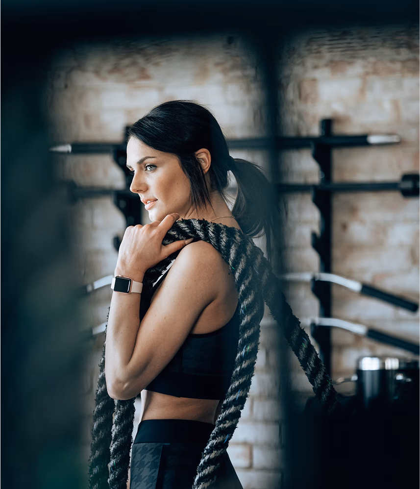 Athlete carrying battle ropes in a gym